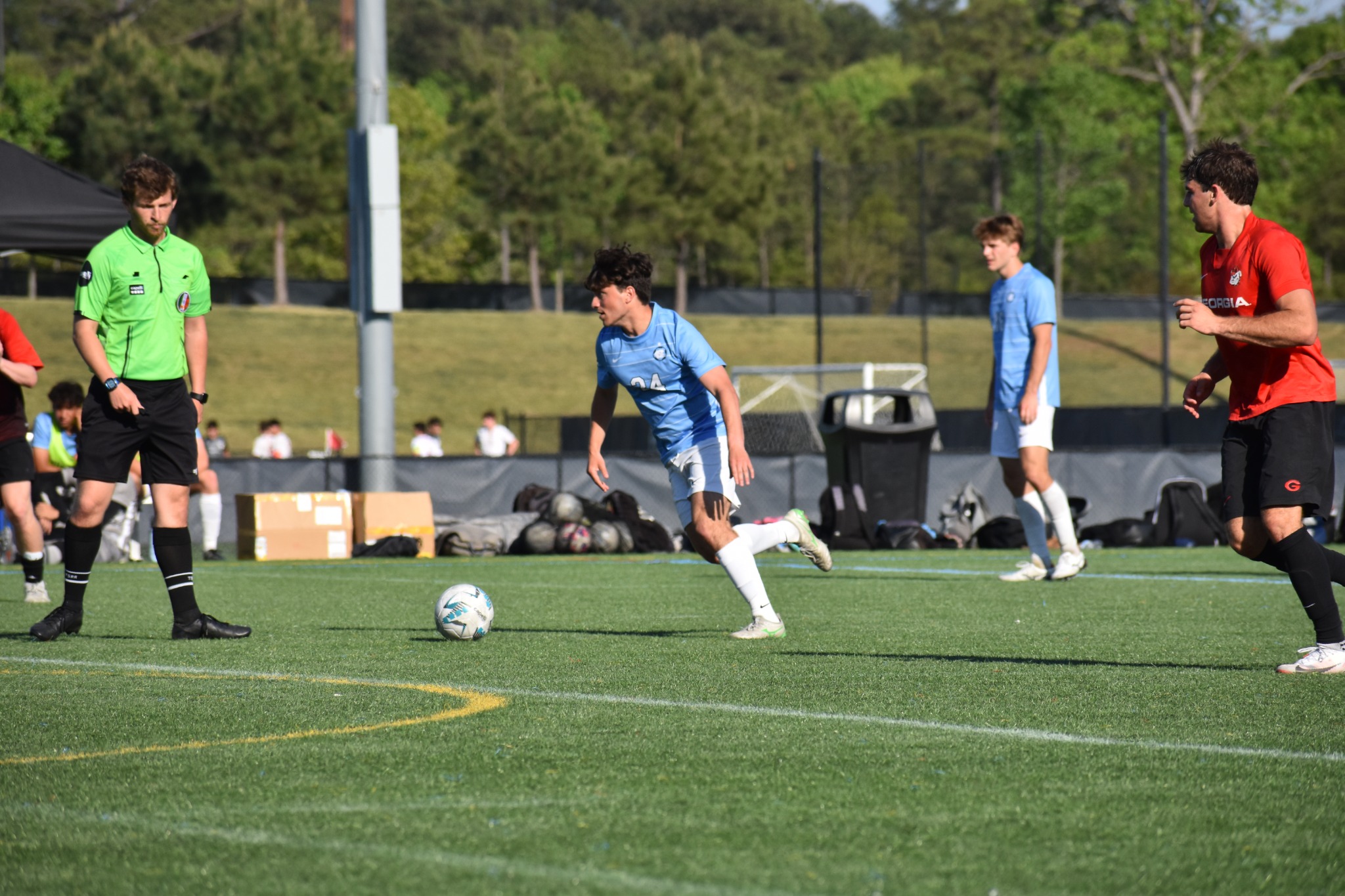 UNC player carrying the ball during a match