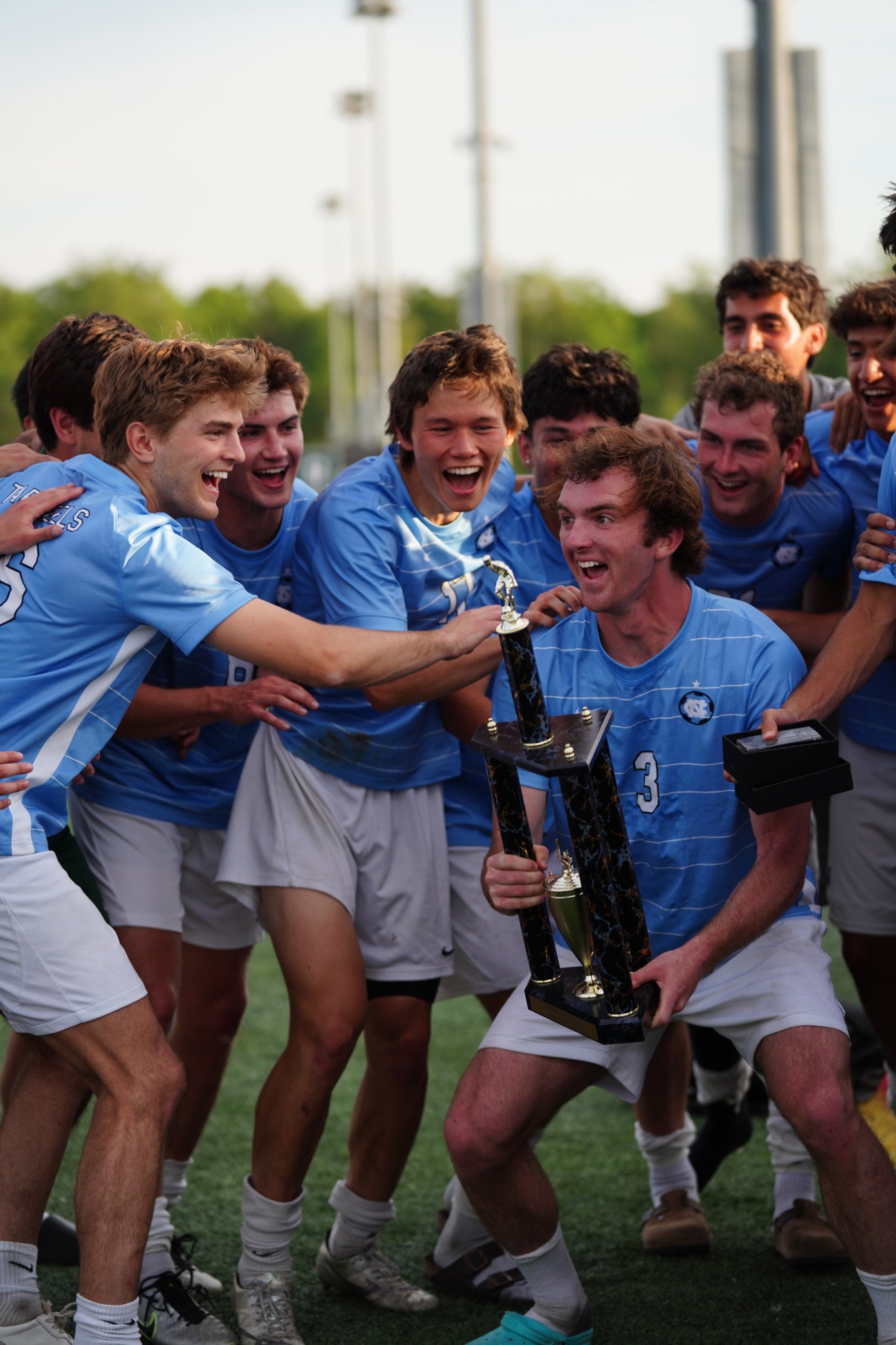 UNC Men's Club Soccer celebrating with the championship trophy